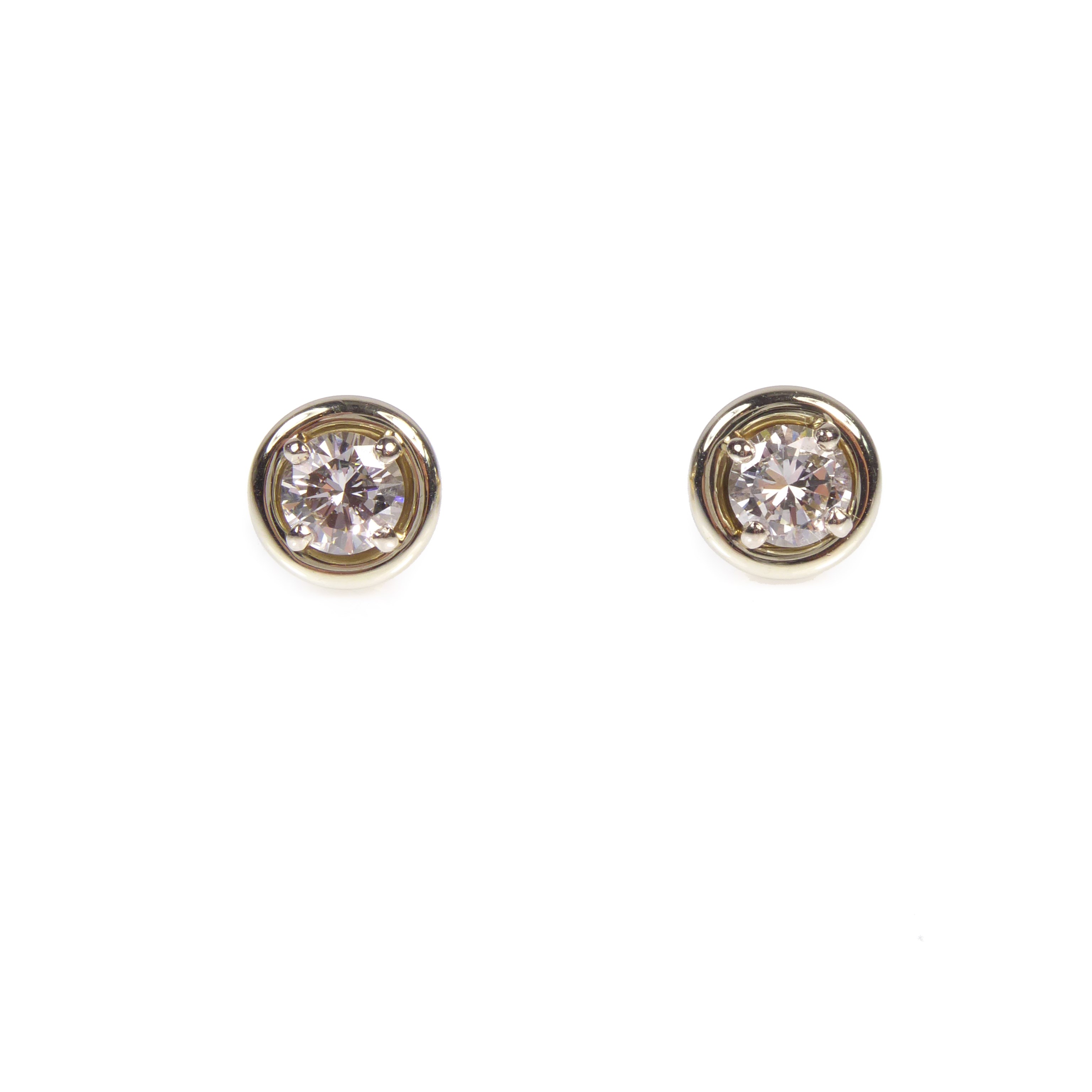 Pair of round brilliant cut diamond stud earrings by Cartier